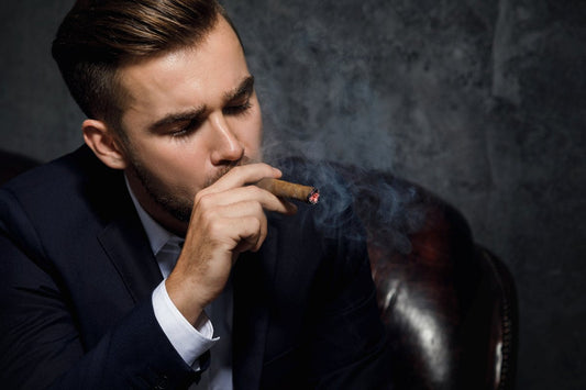 Portrait of handsome rich man is smoking cigar